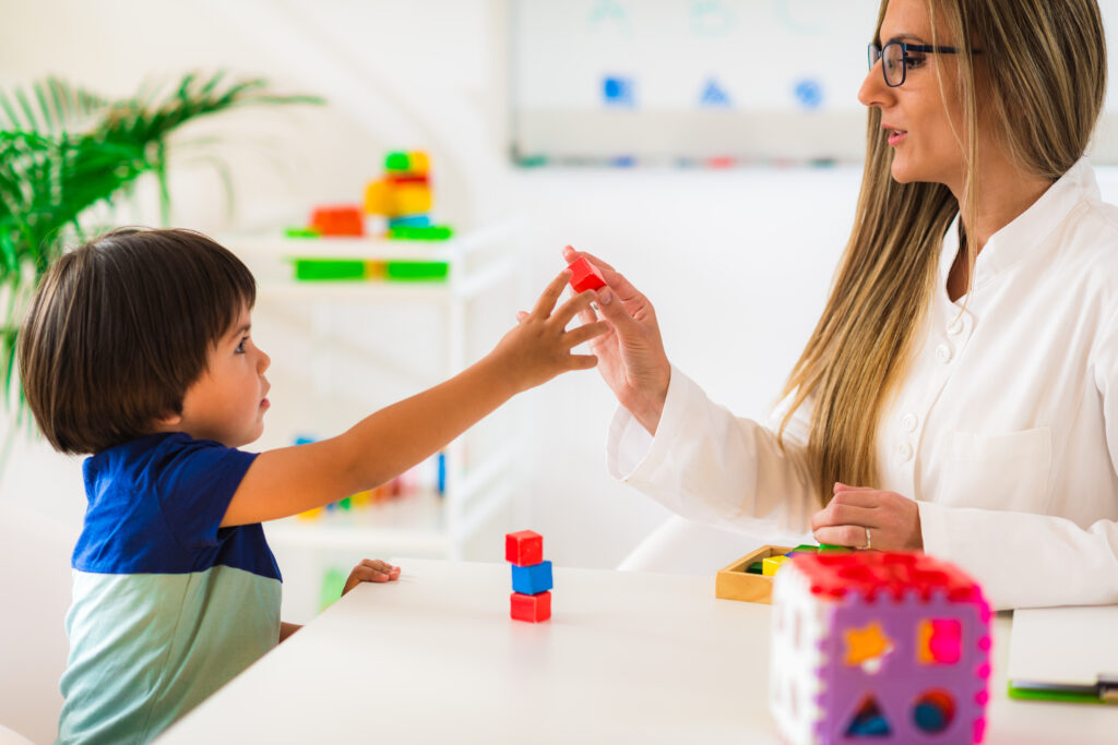 Child psychology, little boy making tower with blocks